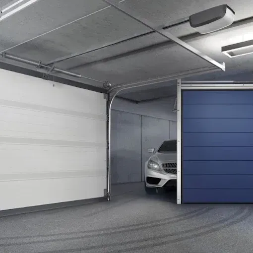 Modern garage with white and blue sliding doors, partially open to reveal a parked car inside.