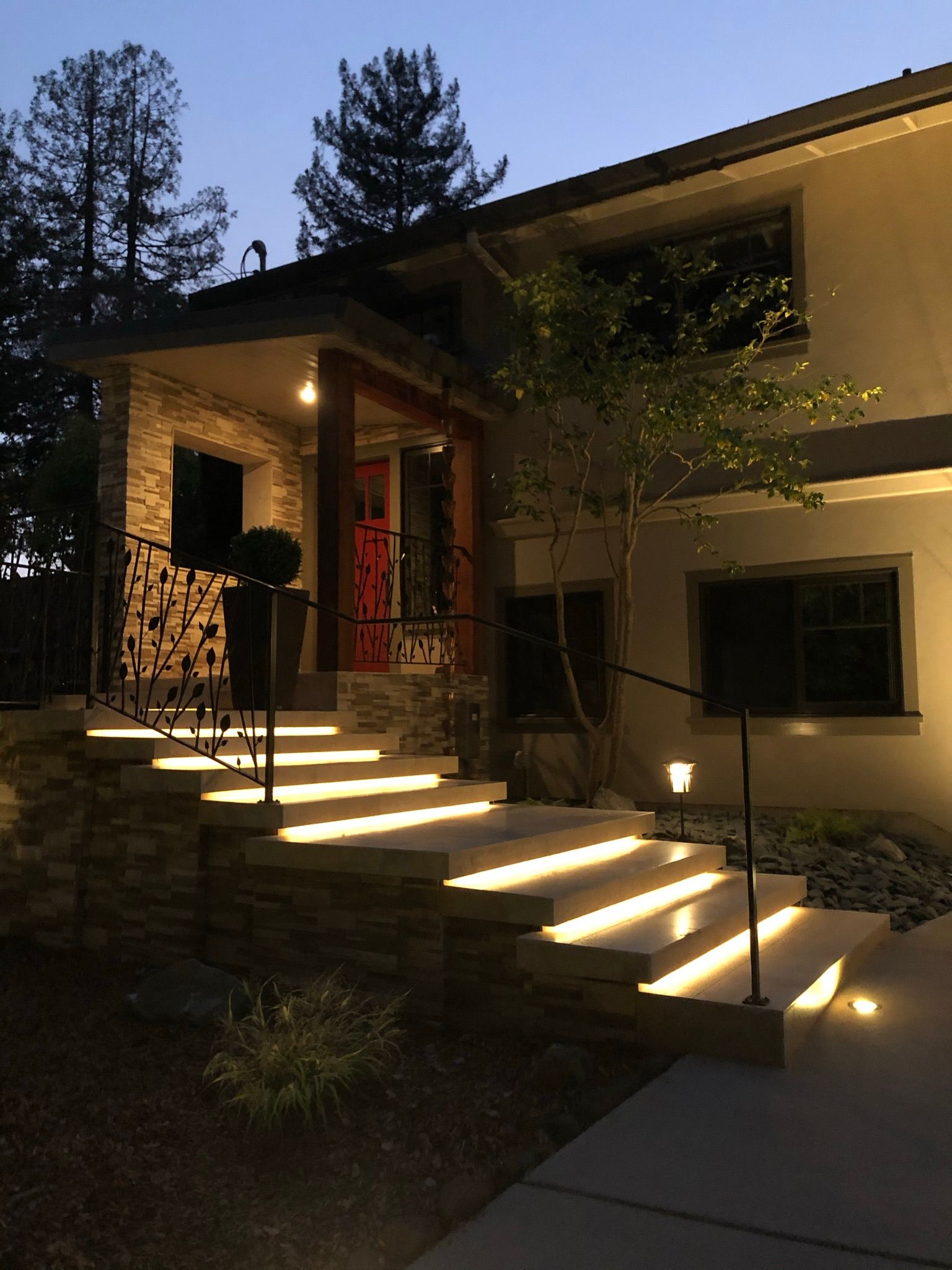 A house with stairs that are lit up at night