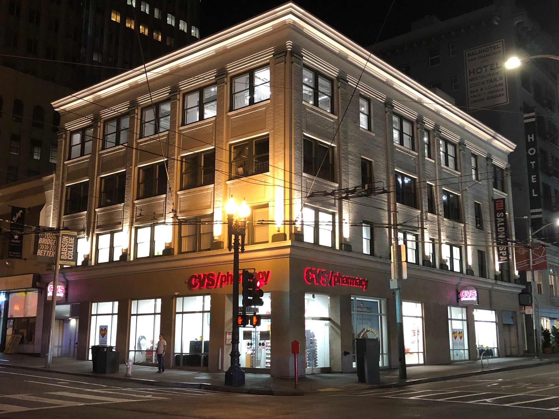A large building with a lot of windows is lit up at night.