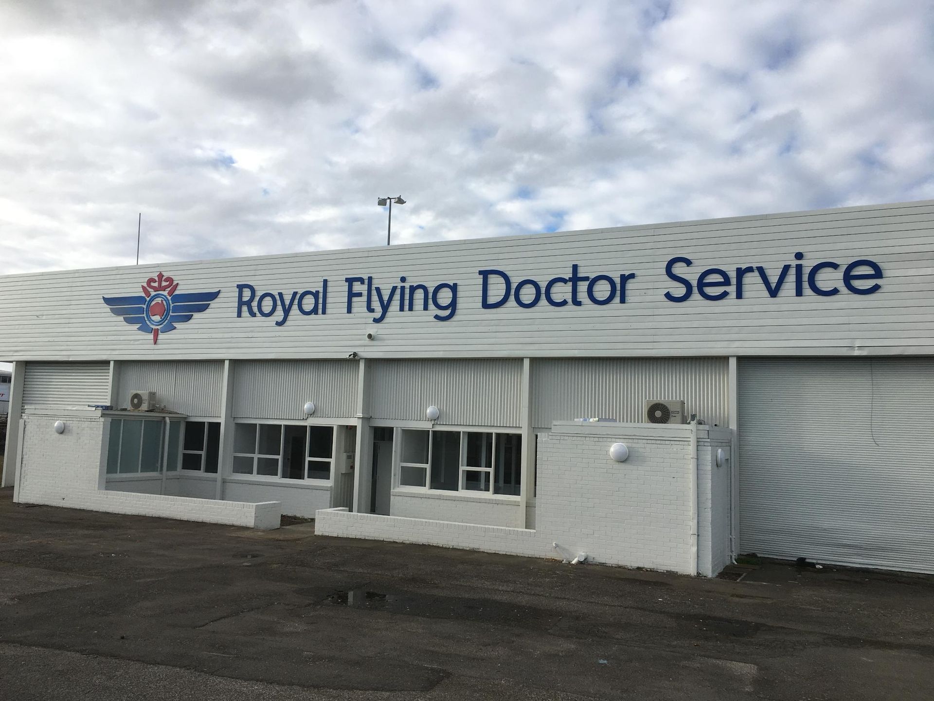 A white building with a sign that says royal flying doctor service