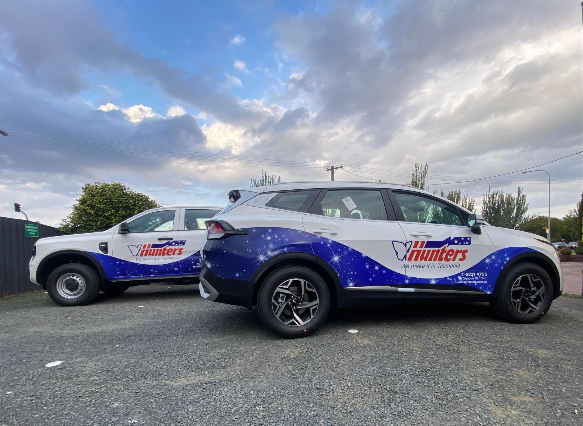 A red , white and blue airplane is on a trailer next to a truck.