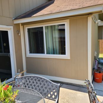 Handyman working on exterior home repairs with professional tools.