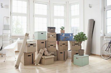 Stack of cardboard boxes in empty apartment