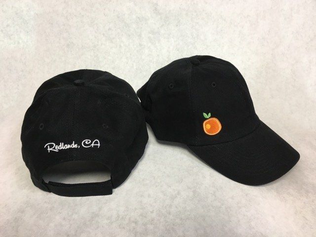 A black baseball cap with an orange embroidered on it