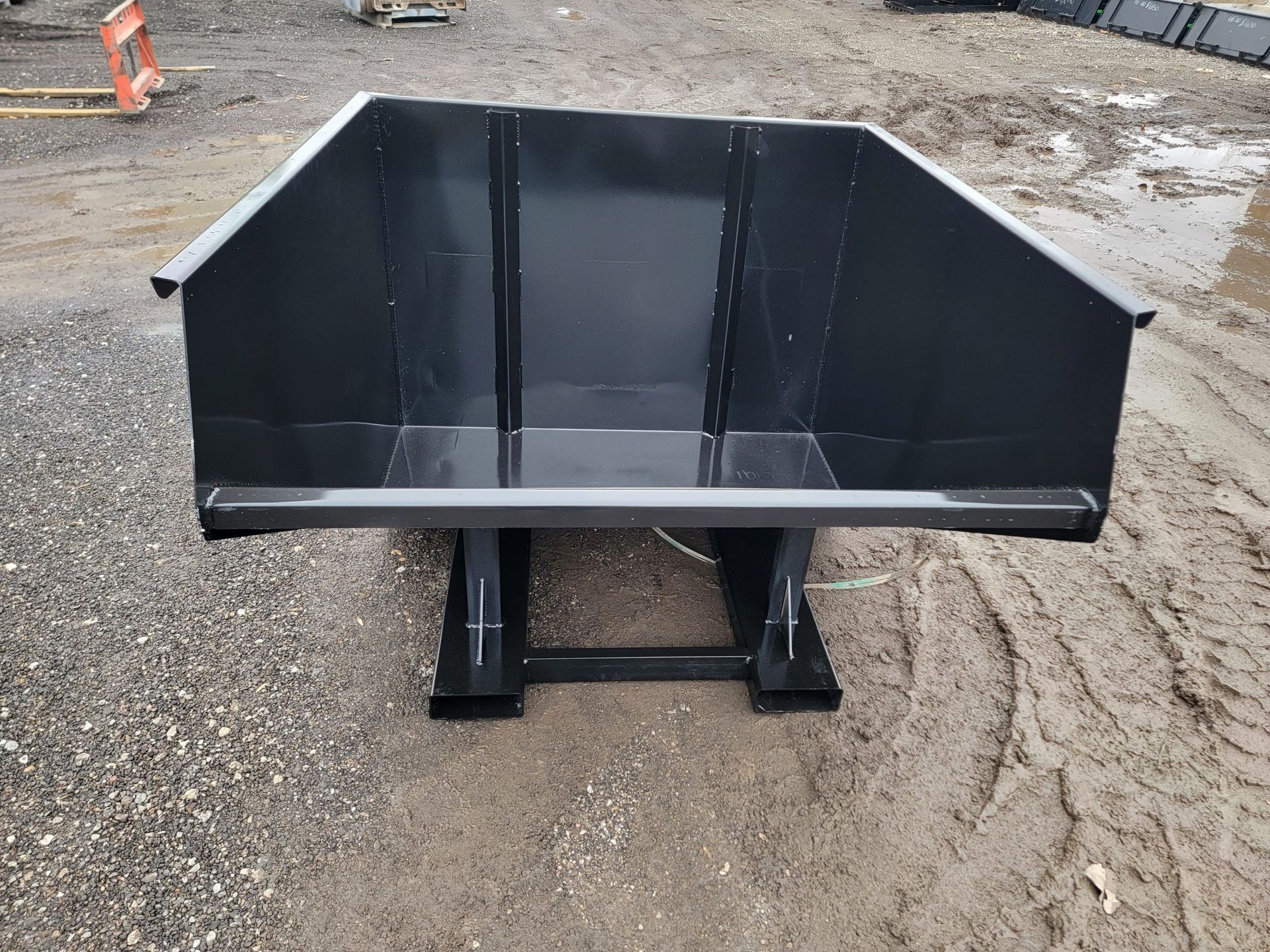 A black dumpster with a yellow sticker on it on a white background.