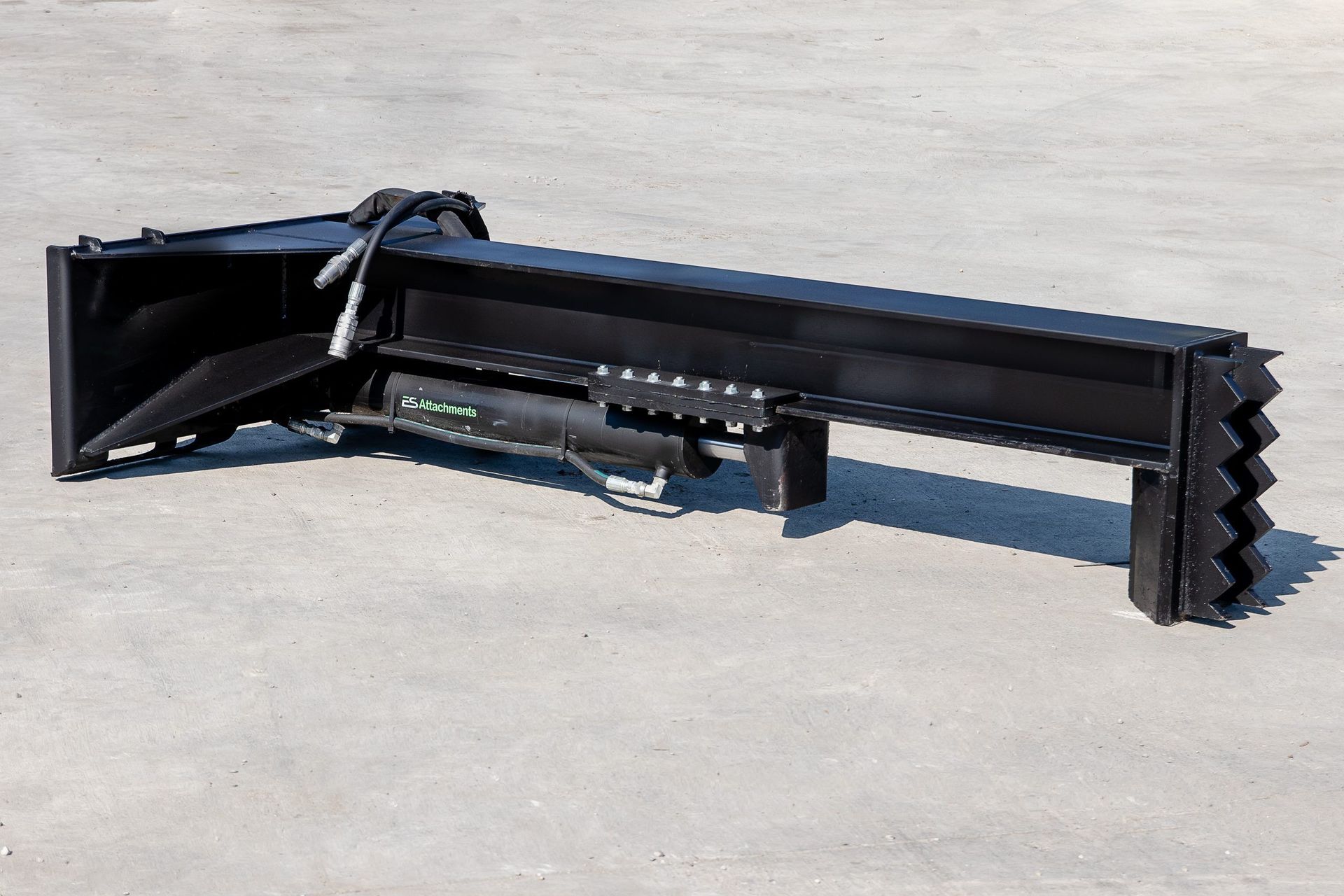 A black metal object is sitting on a concrete surface.