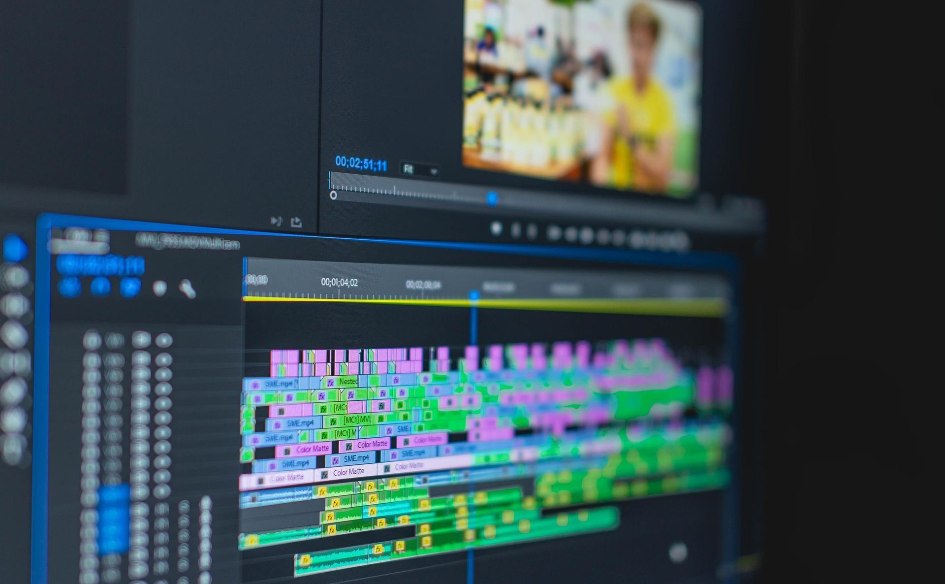 Video editing software interface on a computer screen, with colorful timeline and preview window showing a person.