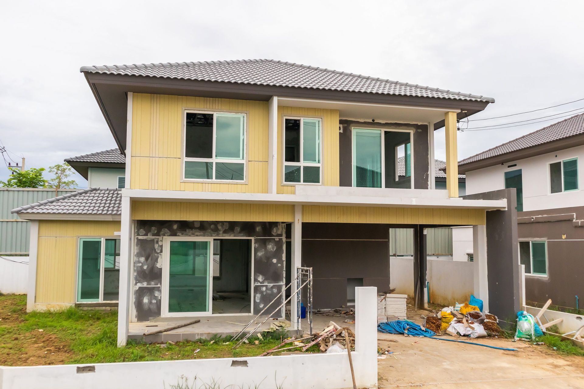 Two-story house under construction with gray roof
