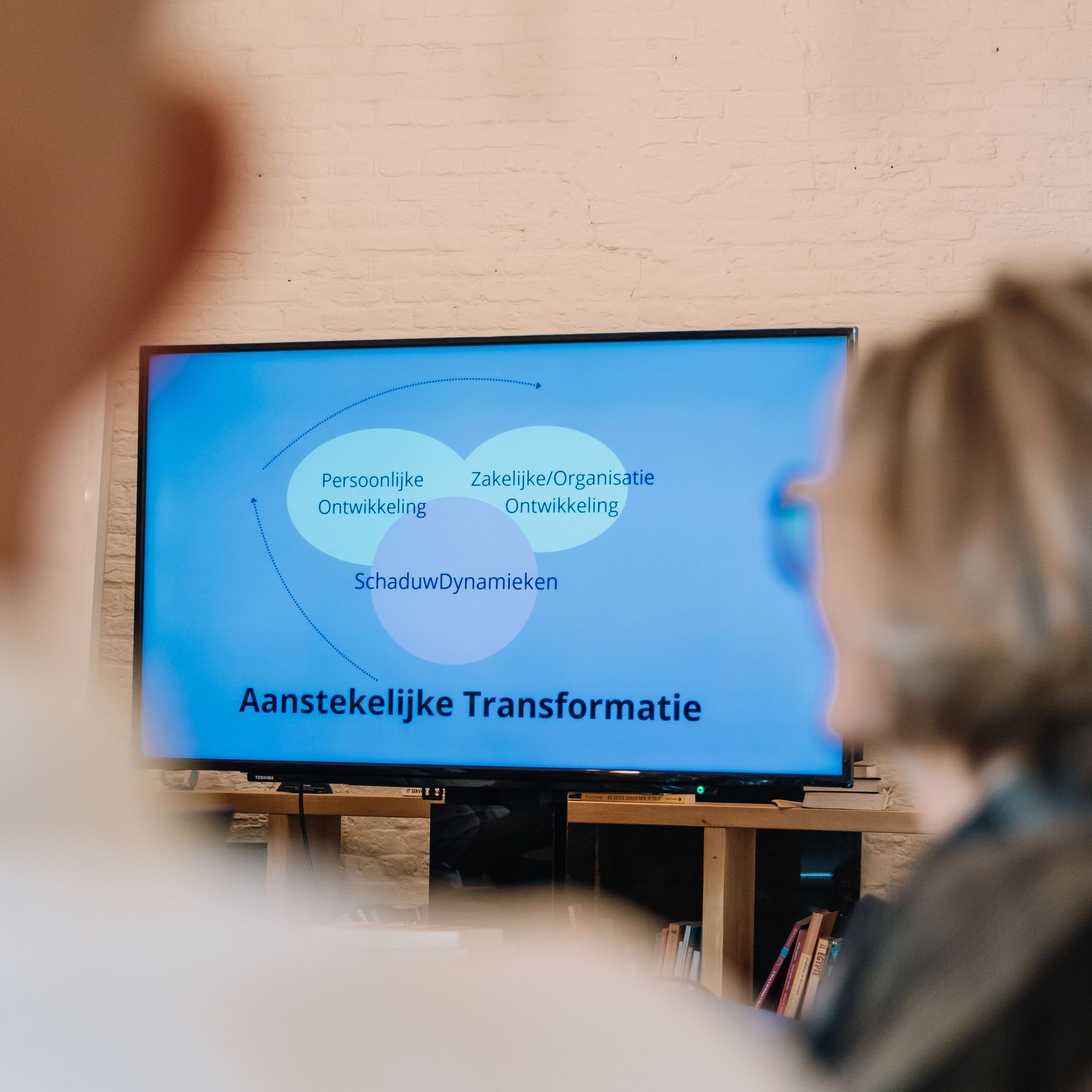 Two people watching a presentation on 