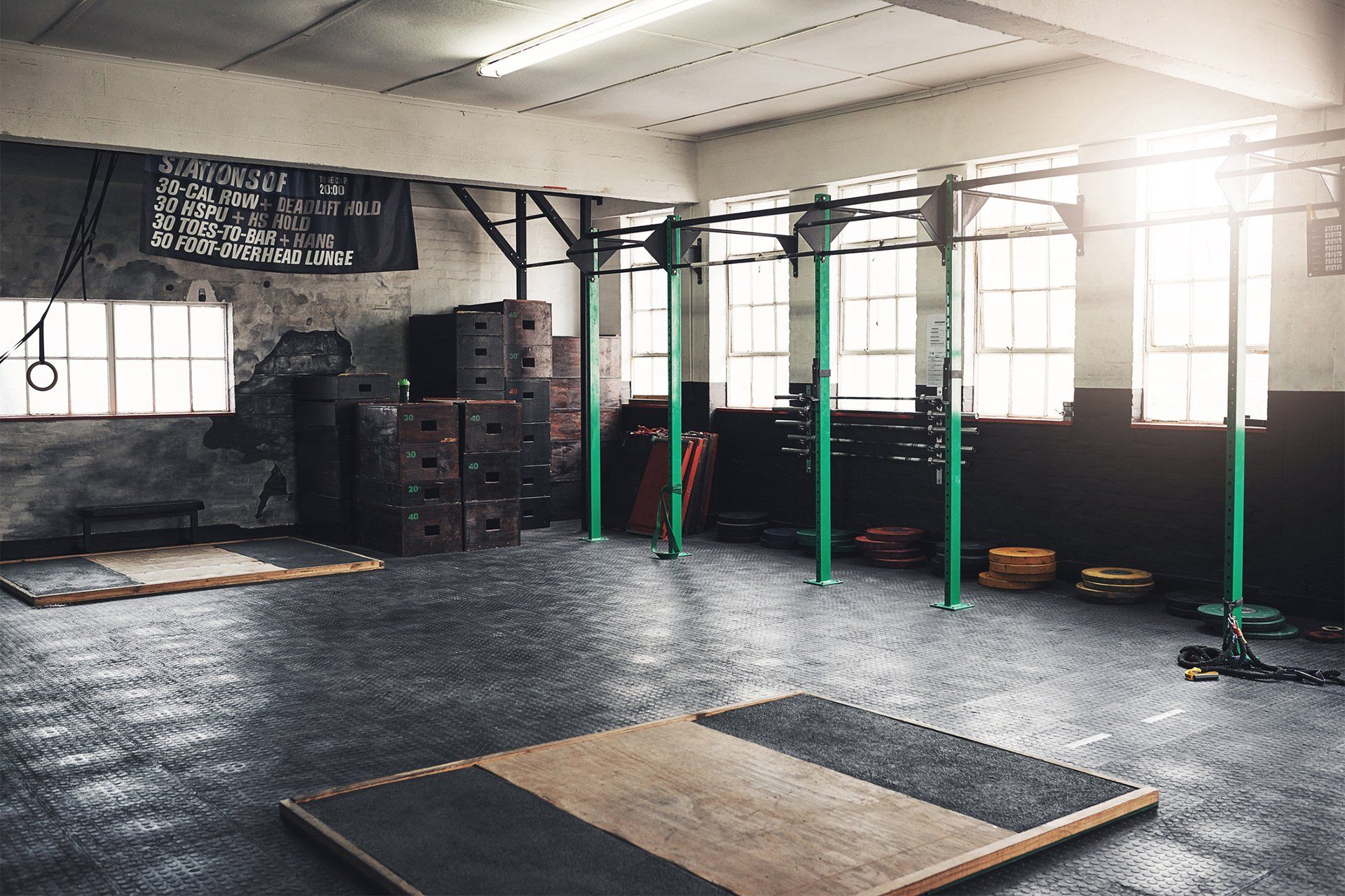 an empty gym with a wooden platform in the middle of it .