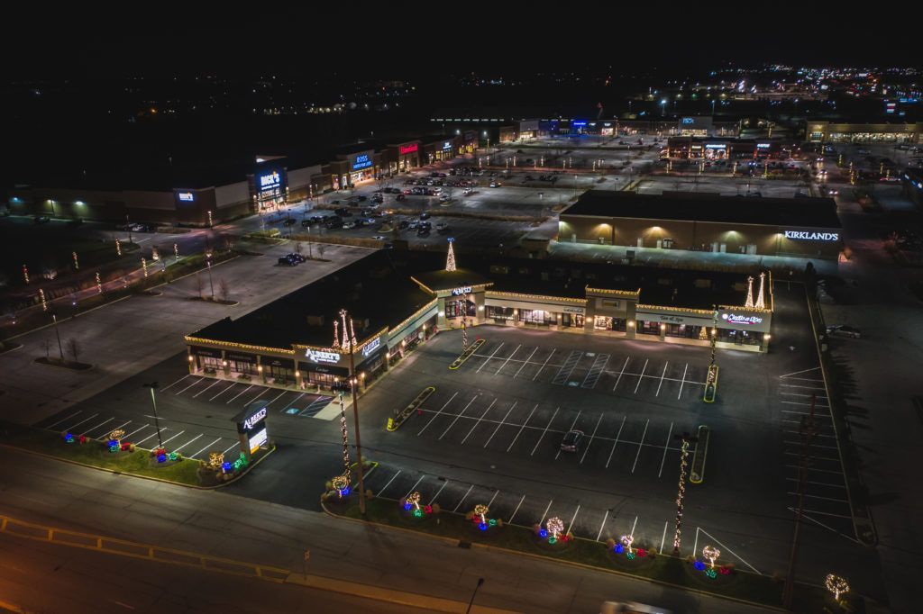An aerial view of a shopping center at night.