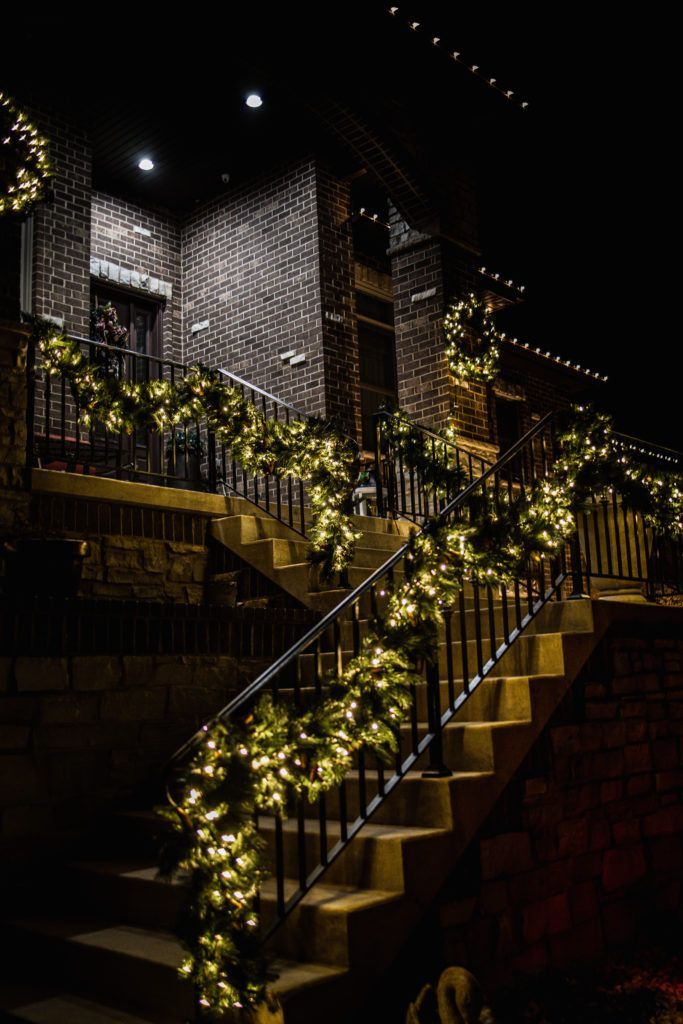 A set of stairs decorated with christmas lights at night.