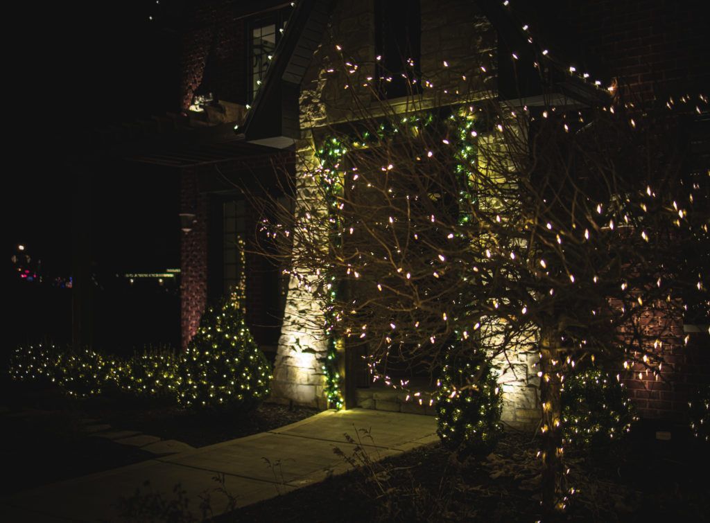 A house is decorated with christmas lights at night.