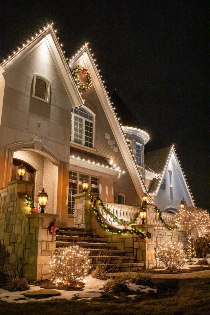A house is decorated with christmas lights at night.