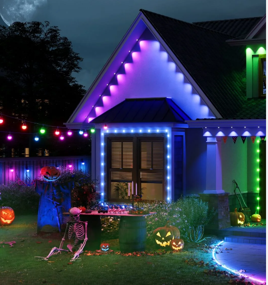 A house decorated for halloween with a skeleton and pumpkins