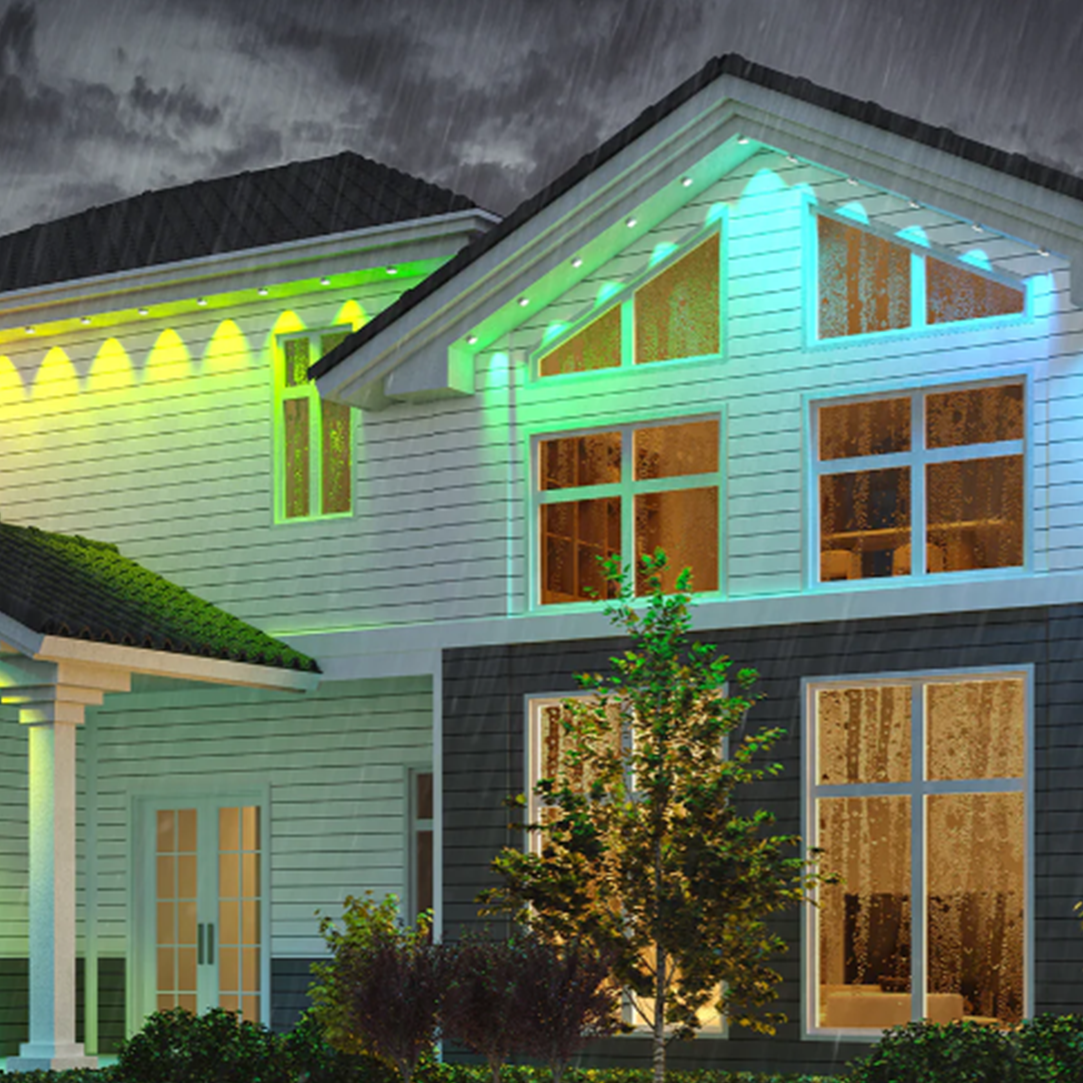 A house with a lot of windows is lit up at night