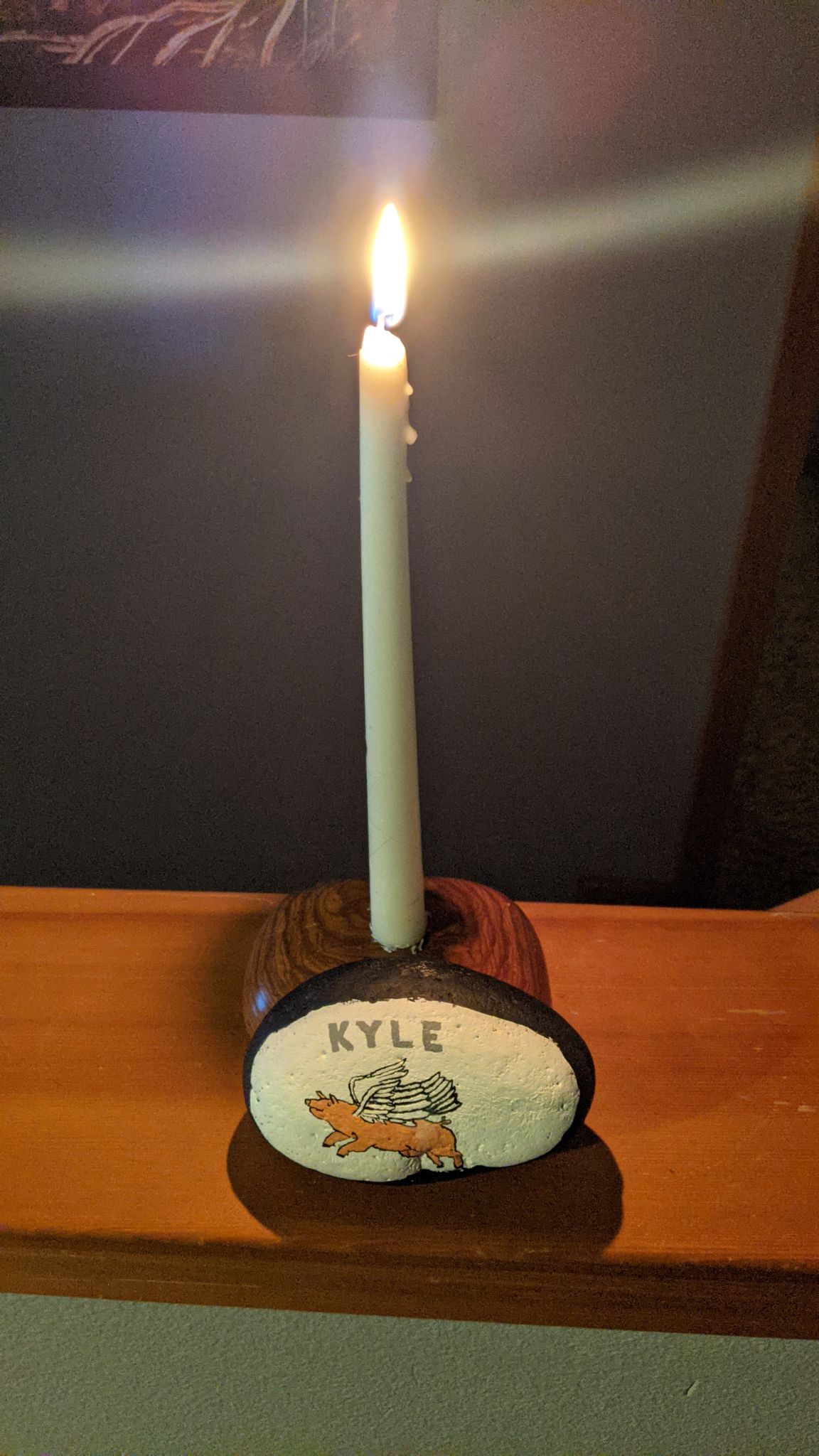 painted rock and candle