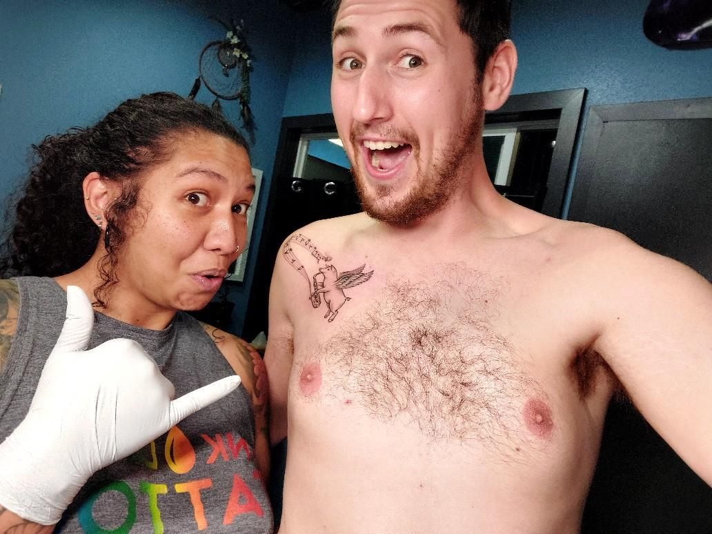 Alexander and Susan showing Alexander's tattoo