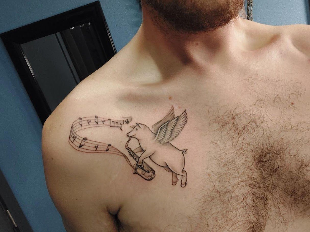 Alexander and Susan showing Scott's tattoo