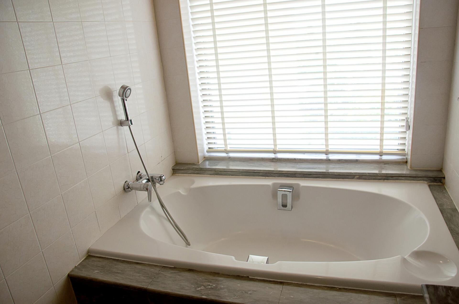 bathroom with bathtub and shower
