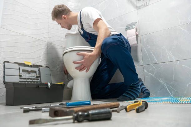 Man Installing New Toilet Bowl — Ponte Vedra Beach, FL — Van Worz Plumbing Inc.