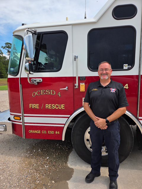 A man standing in front of a red Orange County fire tanker truck Christopher Jagoe