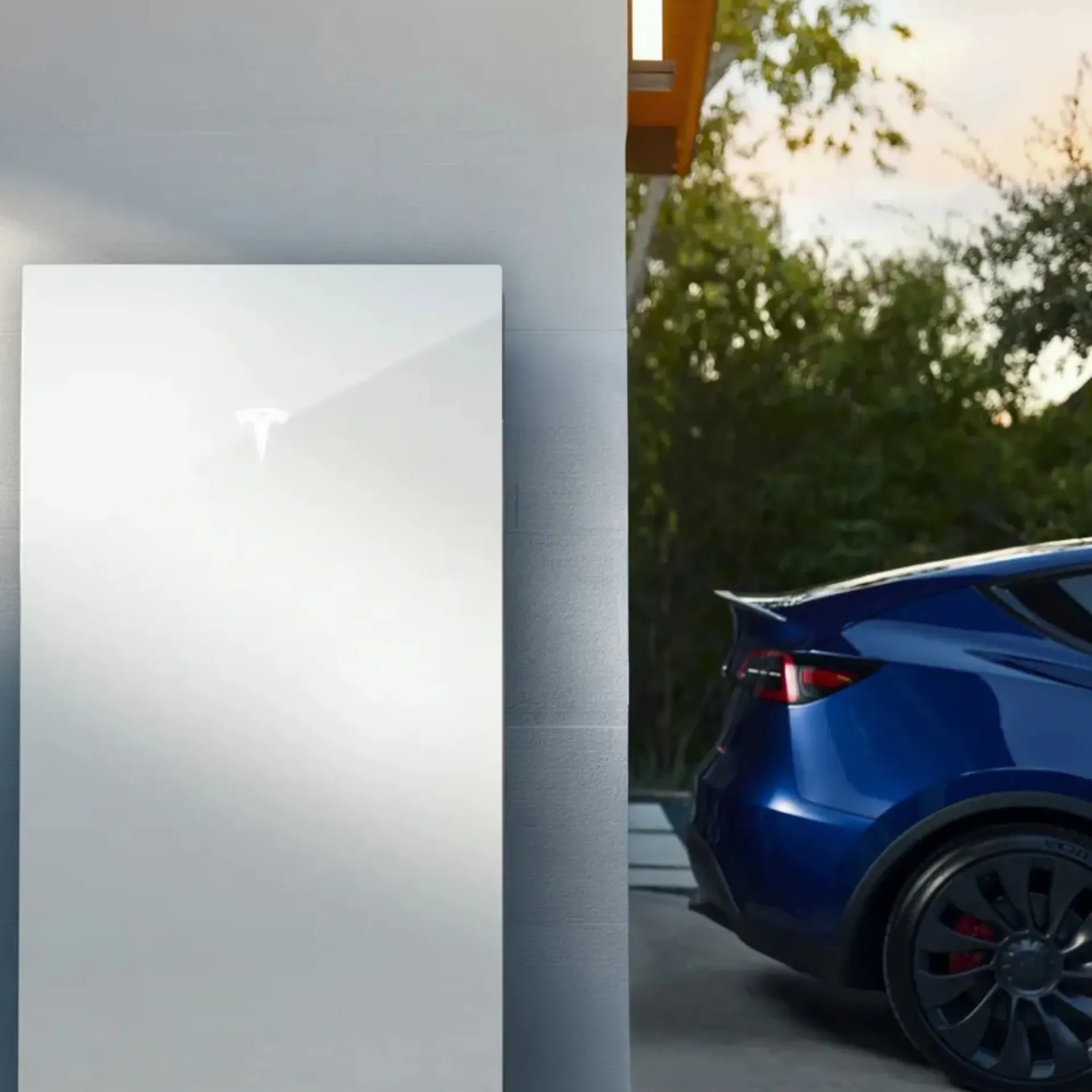 OE Services LLC - A blue tesla model s is parked next to a white wall.