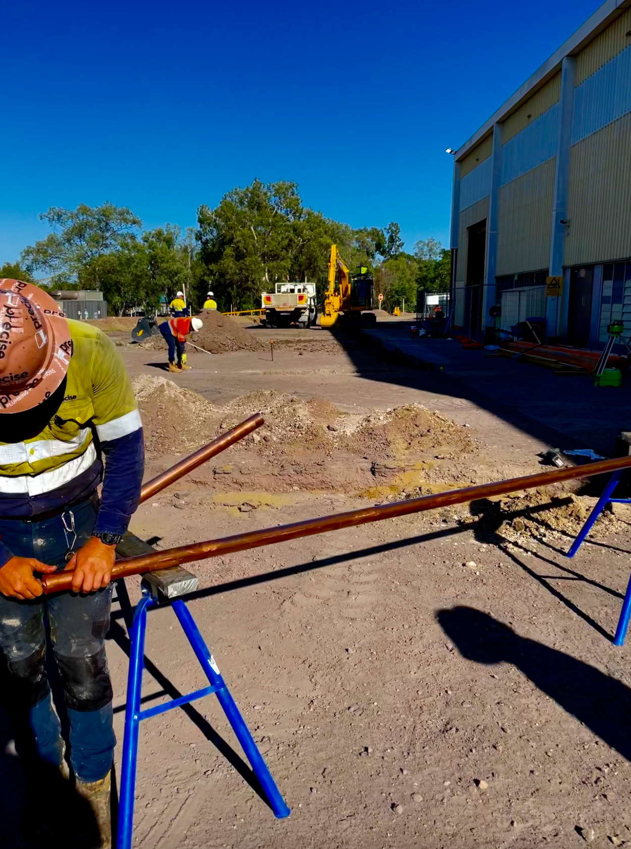 A Person is Fixing a Water Valve With a Wrench — Precise Plumbing & Excavations Pty Ltd in Bowen, QLD