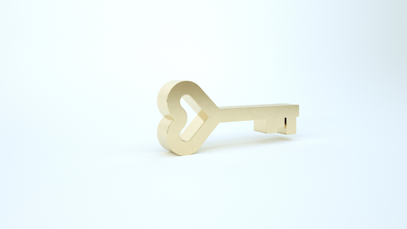 Beige key with a heart-shaped bow on a light background
