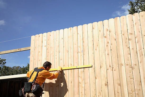 Man building wood fence