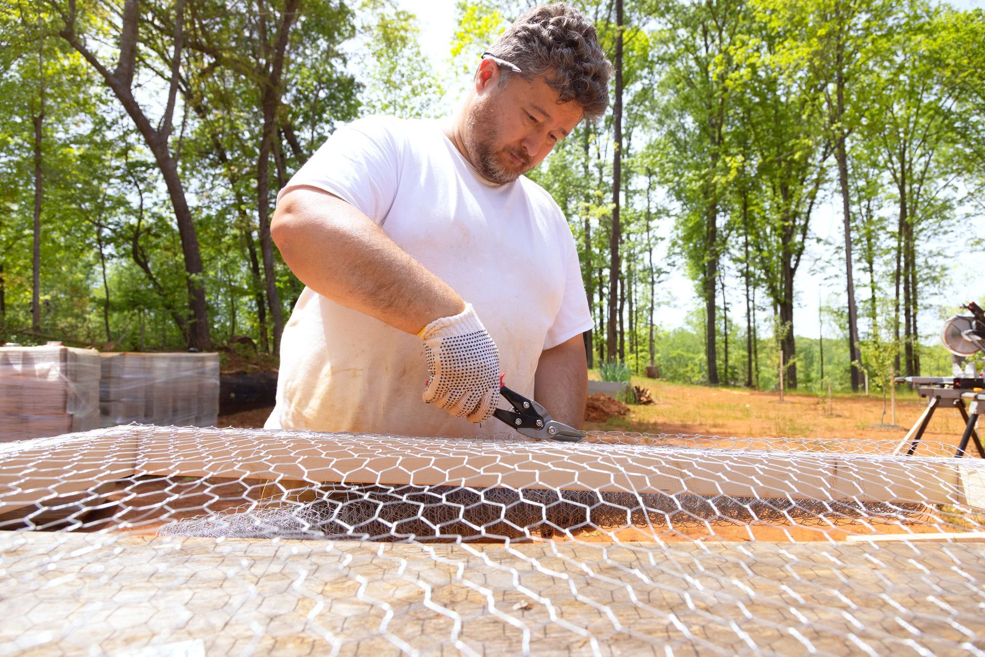Man cutting wire mesh