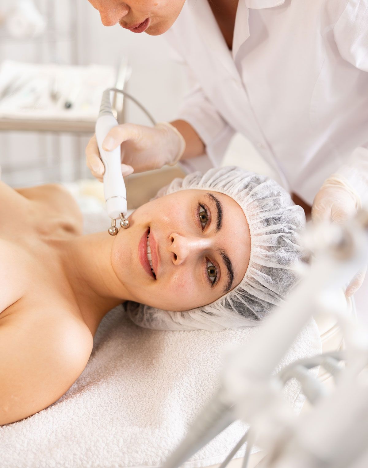 A woman is getting a facial treatment at a beauty salon.