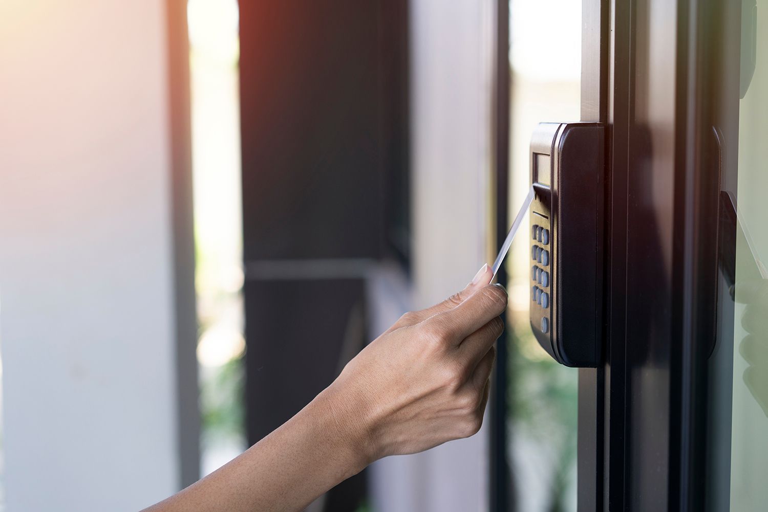 A person is using a card to enter an office building.