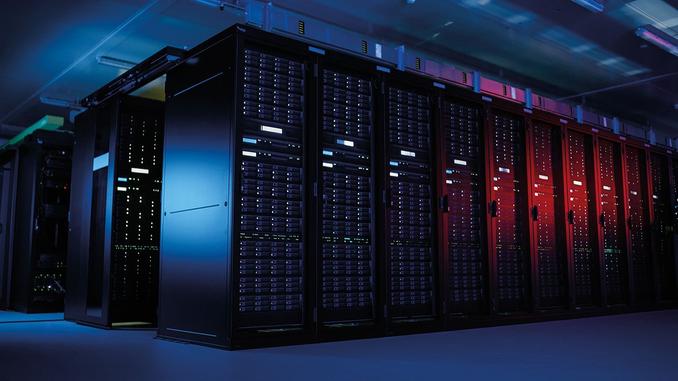 A row of servers in a data center with blue and red lights.