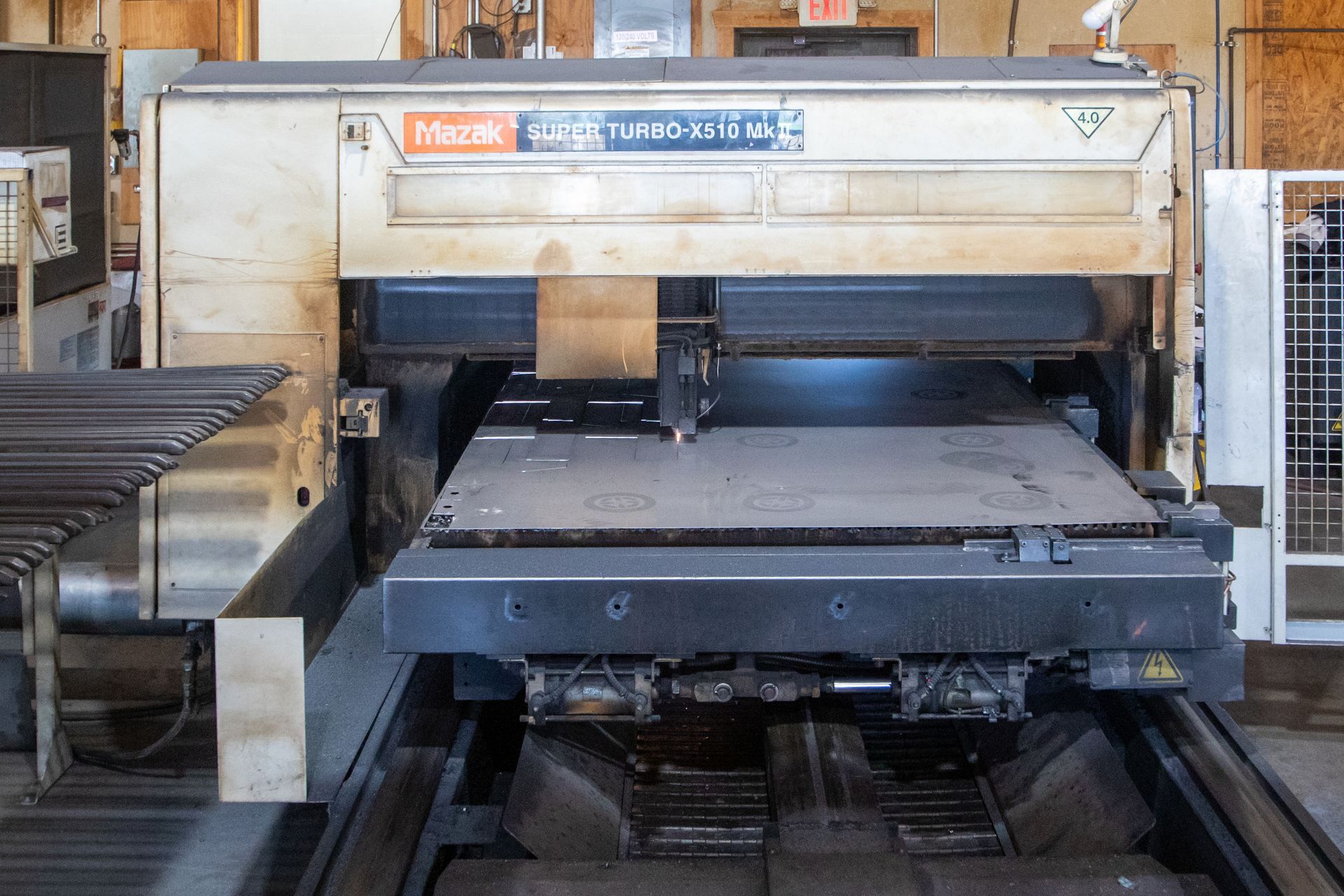 Large industrial metal cutting machine in a factory setting.