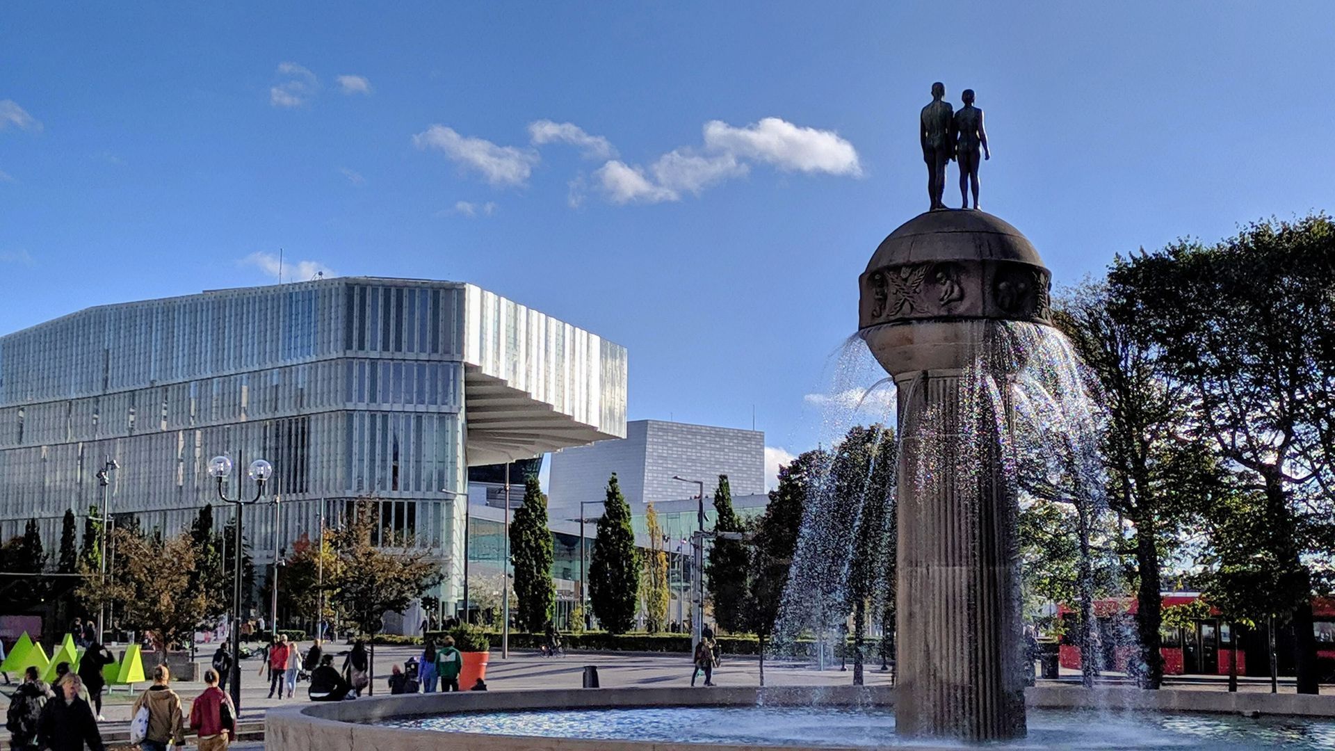 Sunny Oslo morning features Kristian Frederik Plass with a local fountain and modern architecture