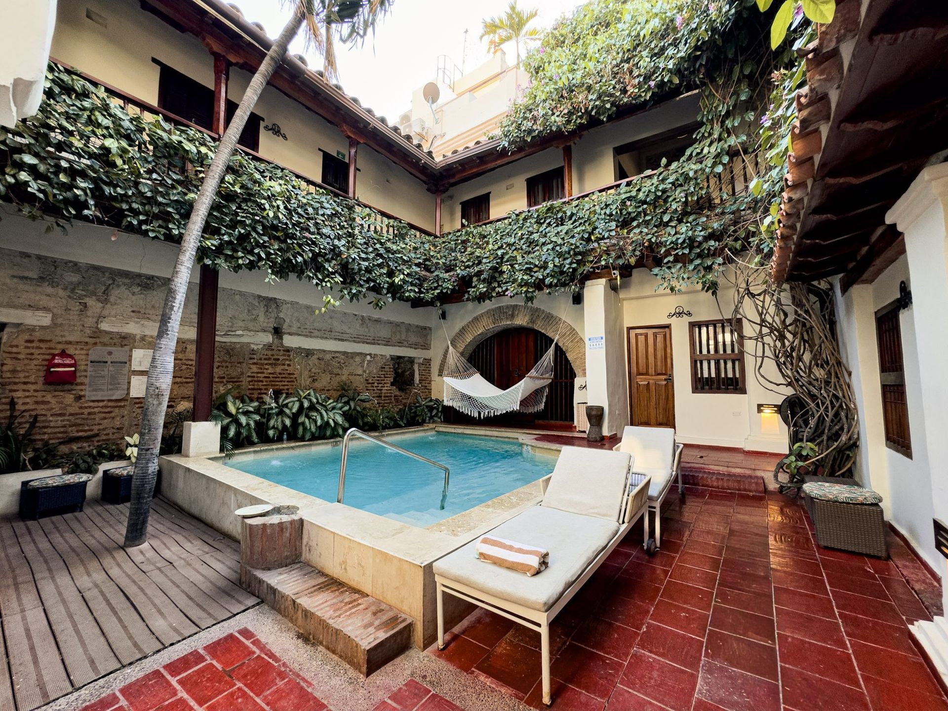 Pool deck with loungers at Casa Bugó hotel, Cartagena