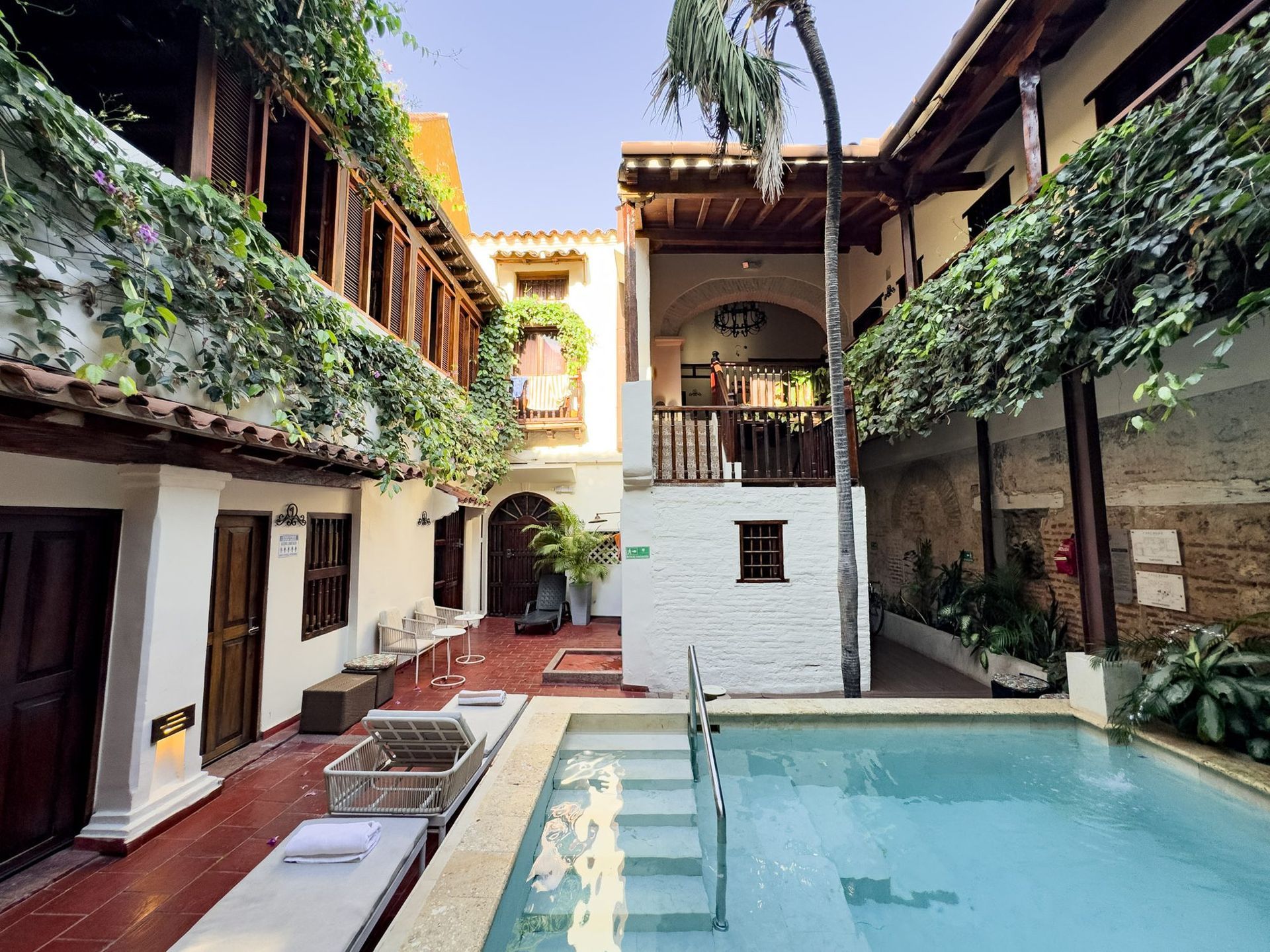 Courtyard pool surrounded by colonial balconies at Casa Bugó, Cartagena