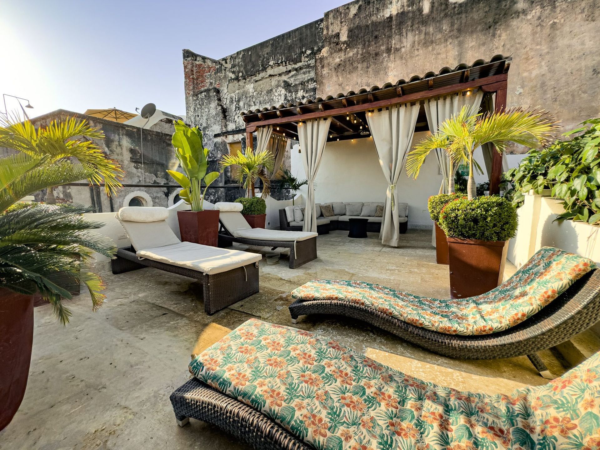 Sun loungers on the rooftop terrace at Casa Bugó hotel