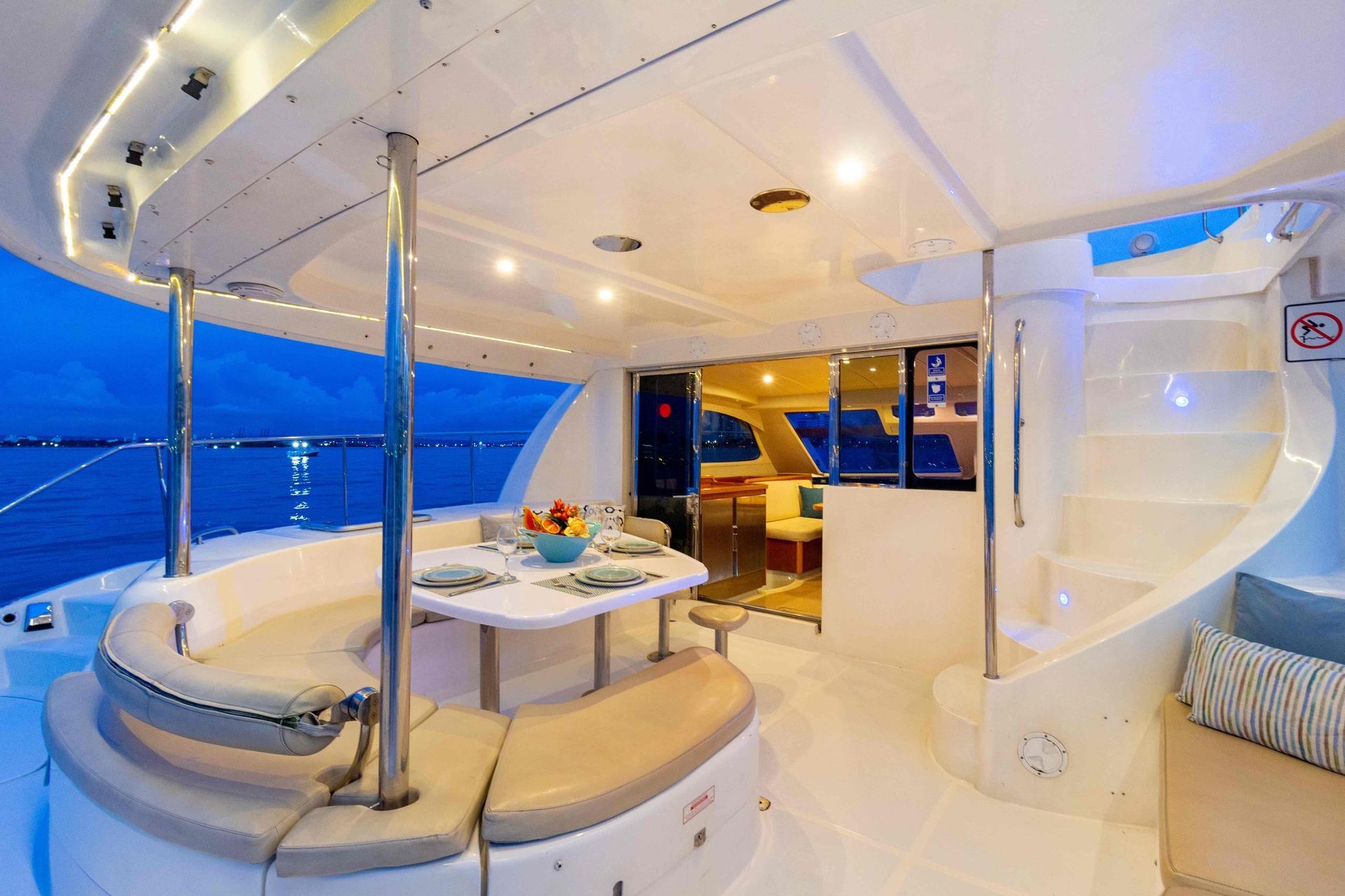 The inside of a yacht with a table and stairs.