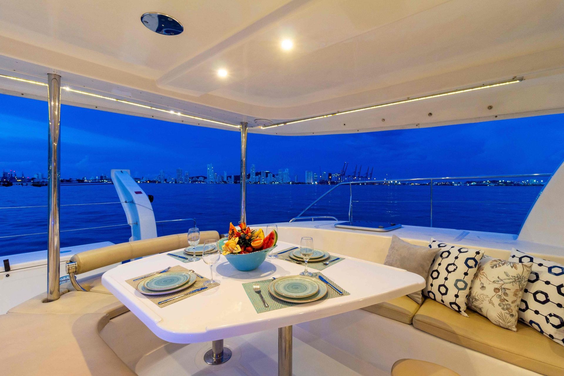A boat with a table and a bowl of fruit on it.