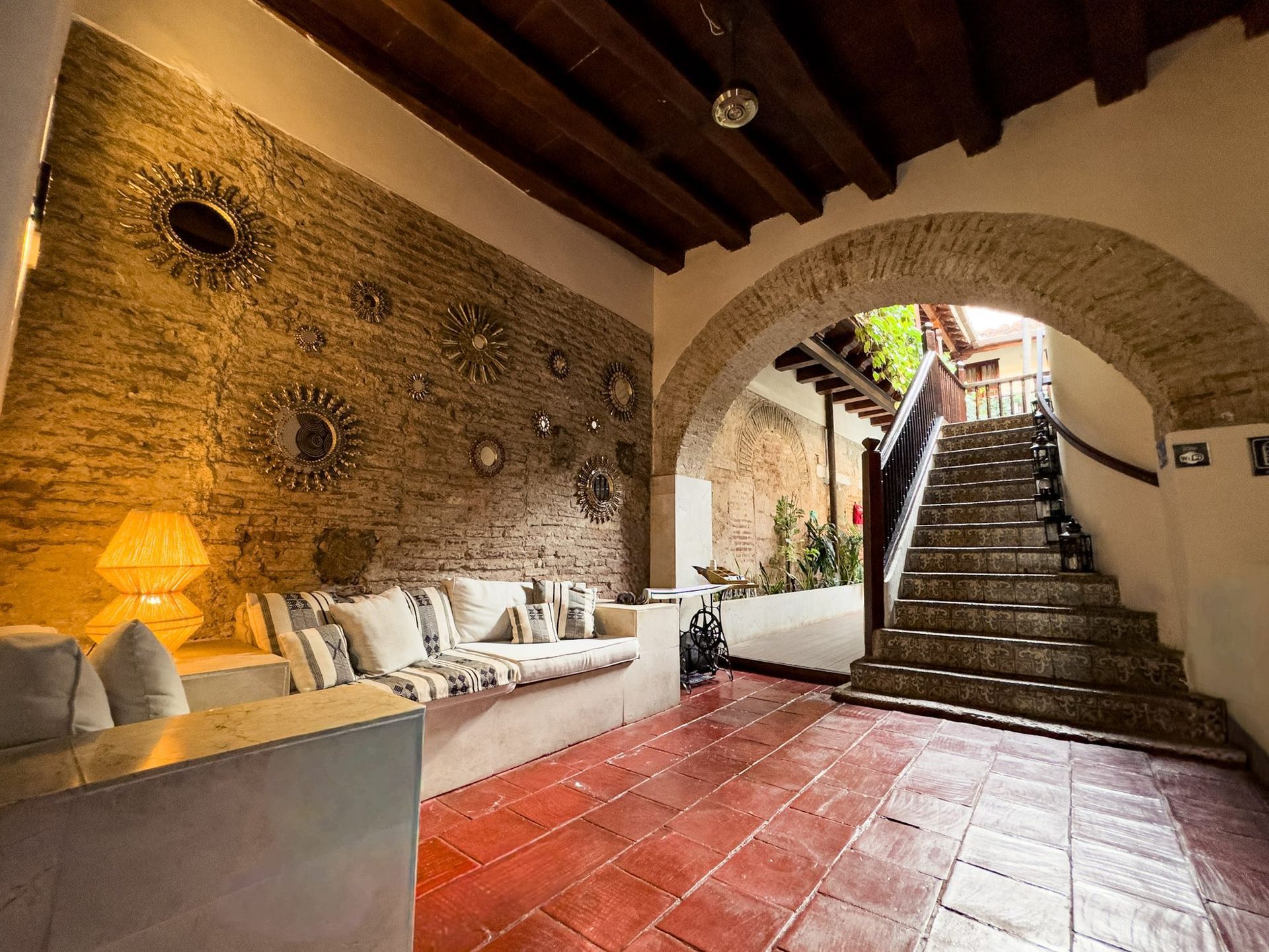 Colonial lounge with stone arch at Casa Bugó, Cartagena