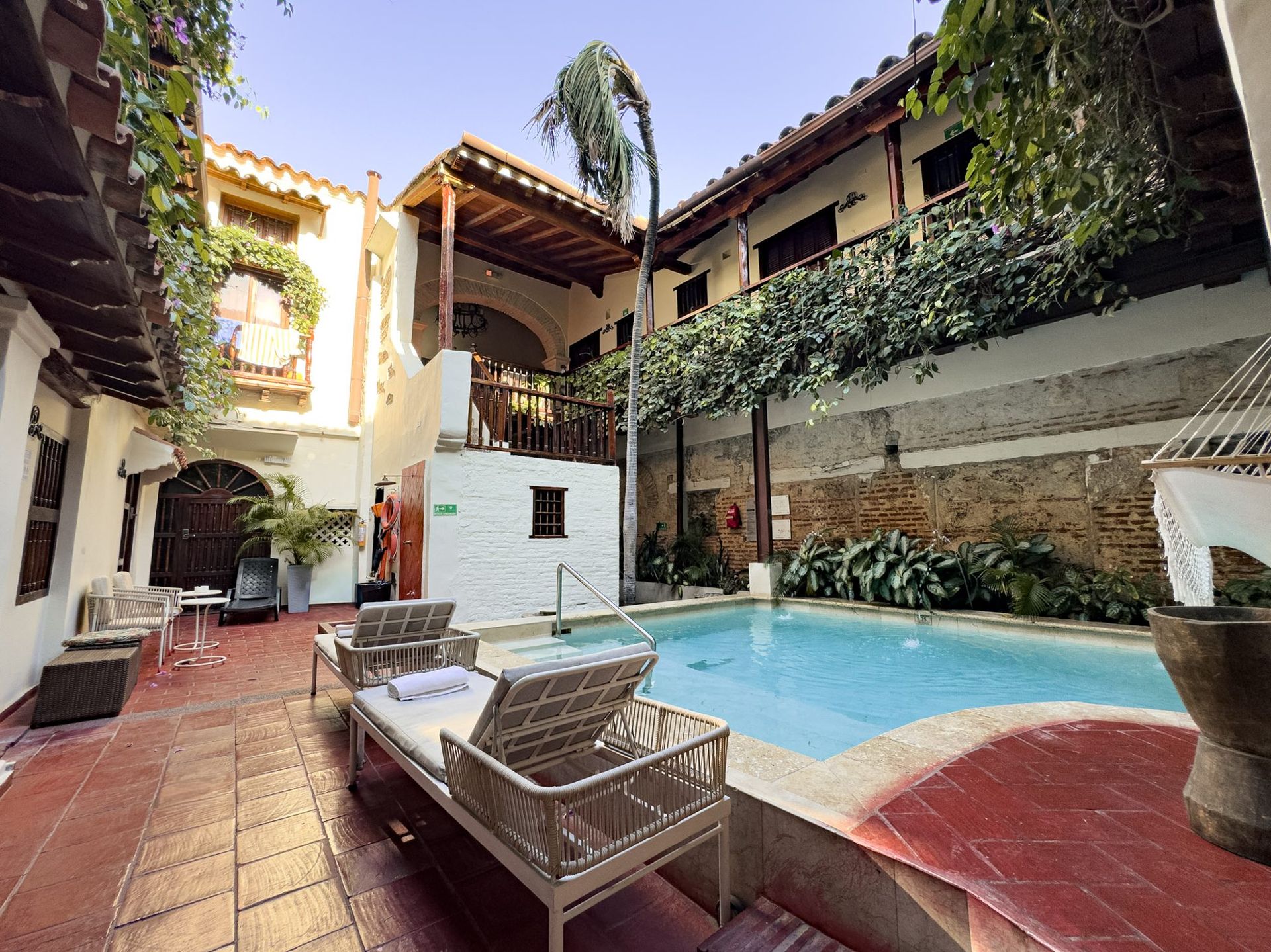 Lounger by the courtyard pool at Casa Bugó hotel