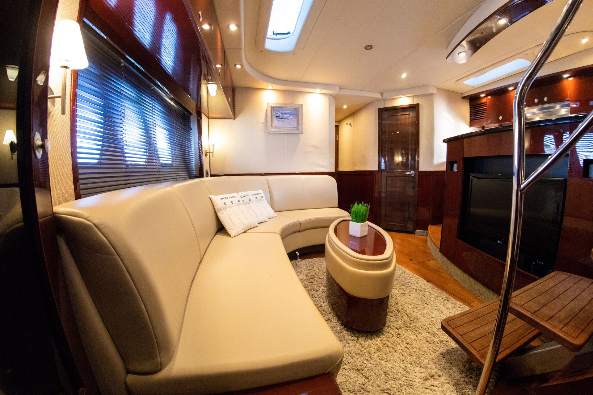 A living room on a boat with a couch and a table