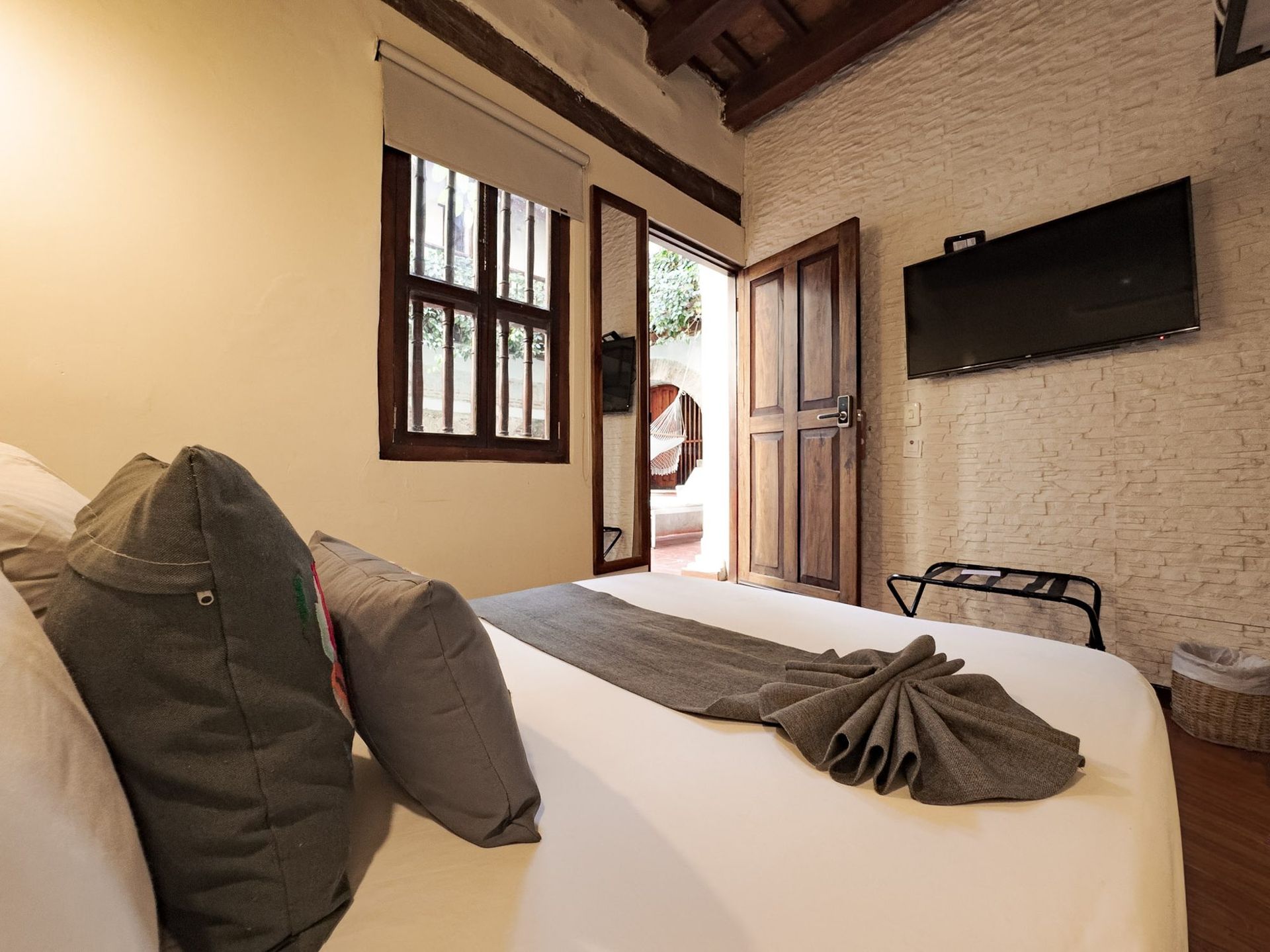 Room with colonial window at Casa Bugó, Cartagena
