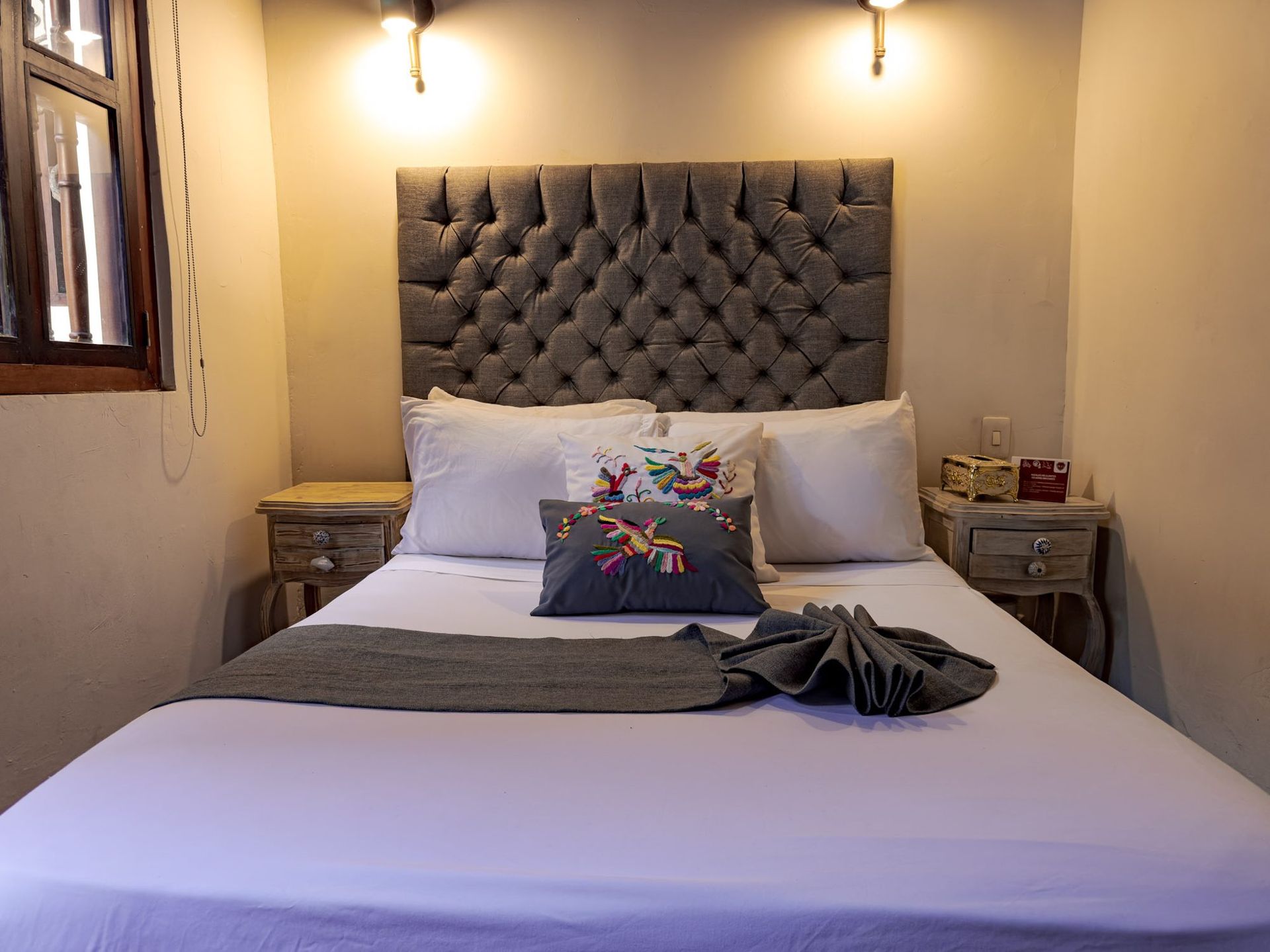 Bed with carved headboard at Casa Bugó, Cartagena