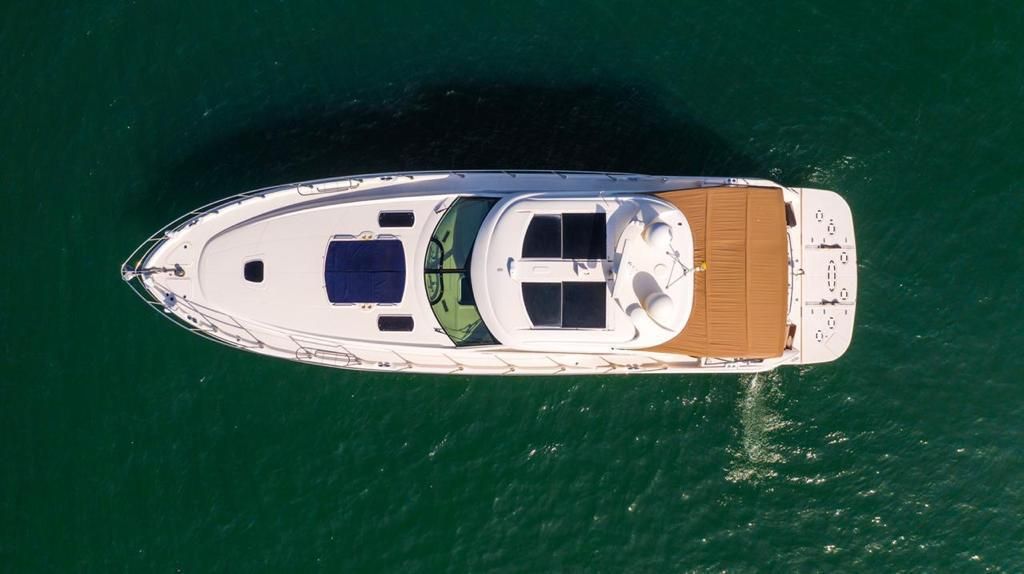 An aerial view of a yacht in the ocean.