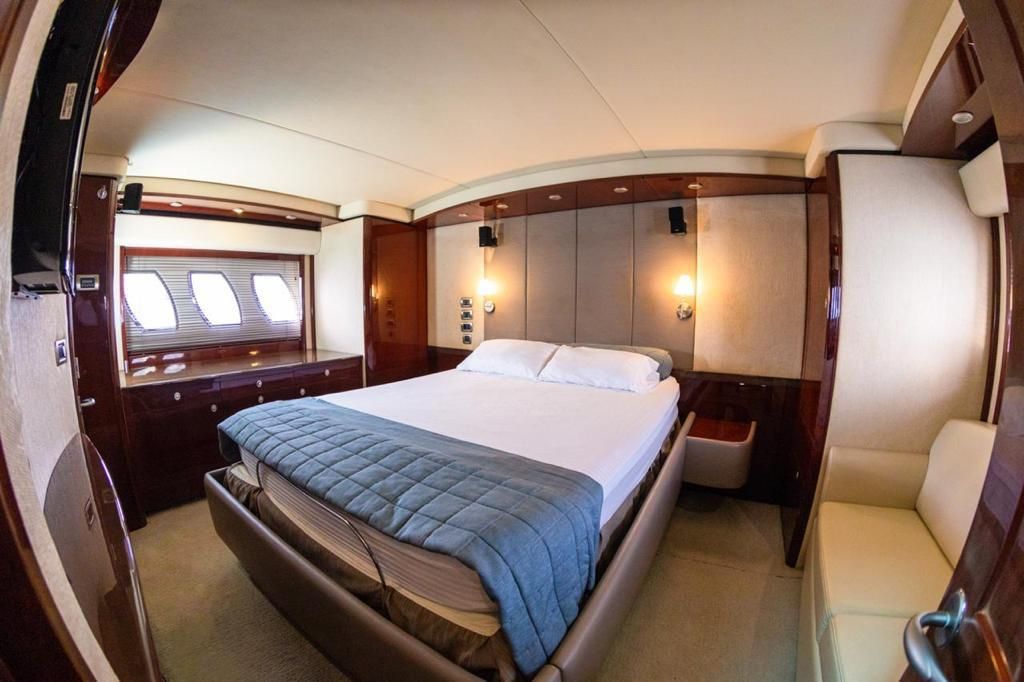 A bedroom on a boat with a large bed and a couch