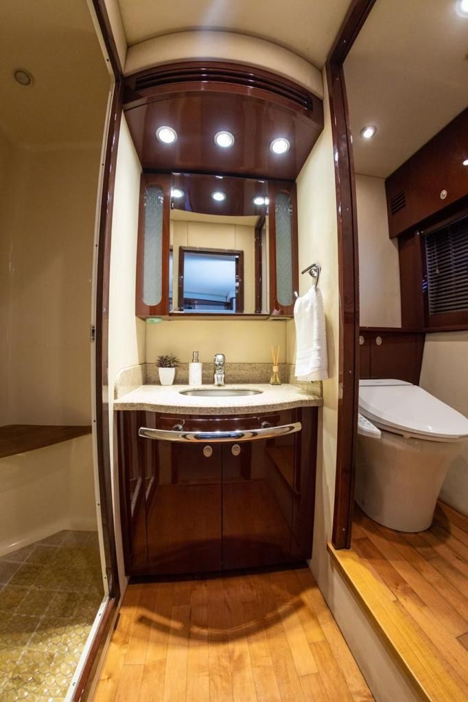 A bathroom with a sink , toilet and mirror.