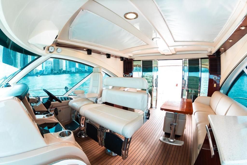 The inside of a boat with a couch and a table